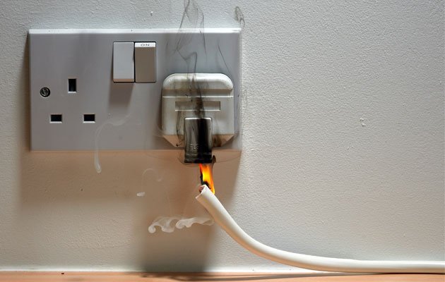 Image showing an electrical socket on fire and smoking